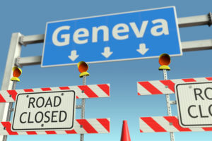Roadblock near Geneva road sign. Coronavirus disease quarantine or lockdown in Switzerland conceptual